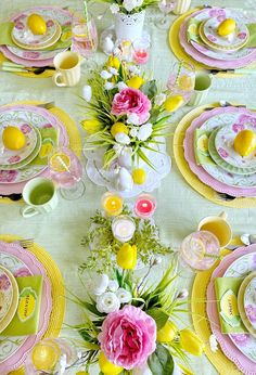 the table is set with yellow, pink and white dishes for easter dinnereons