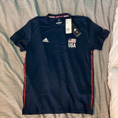 Nwt Adidas Olympic Games Usa Volleyball Navy Blue Short Sleeve Shirt. Unisex. Size S. Fabric Is Stretchy Workout Material. Blue Adidas Tops For Sports Season, Adidas Sporty Tops For Sports Events, Adidas T-shirt For Sports Season Workouts, Adidas Crew Neck Go-dry Tops, Volleyball Fits, Volleyball Team Shirts, Usa Volleyball, Blue Short Sleeve Shirt, Sweats Outfit