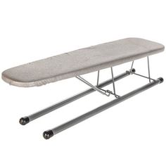 the ironing board is sitting on top of an ironing board stand with wheels