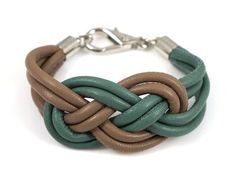 a brown and green bracelet on a white background