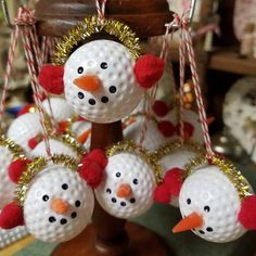 some golf balls with snowmen hanging from them