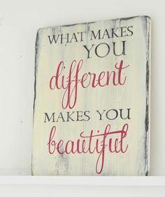 a wooden sign that says what makes you different makes you beautiful on the shelf above it