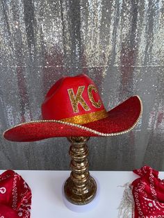 Whose ready for a Super Bowl win?! The perfect accessory to wear to every game, tailgate or friends party you are attending! Order by Feb. 12th to guarantee deliver in time for Super Bowl 2024! This hat features: Red straw hat Option for crystal or RED rhinestones on both brims (as seen in photos) OR just crystal rhinestones on the underneath brim plus all of the below Gold KC letters on the front Gold hat band Gold rhinestone trim on edges Sizing: This hat is a one size fits all! The band on th Custom Red Festival Hat, Red Western Style Party Hat, Red Western Hat For Western-themed Events, Gemstone Cowboy Hat, Pink Rhinestone Cowboy Hat, Red Western-style Party Hat, Rhinestone-embellished Rodeo Hat With Curved Brim, Casual Rhinestone Hat, One Size, Gold Hats