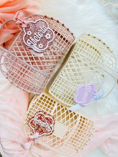 three baskets filled with candy sitting on top of a white table covered in pink flowers