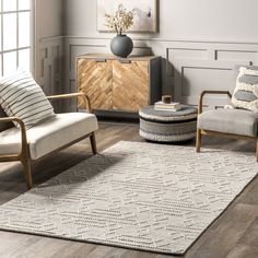 a living room with two chairs and a rug