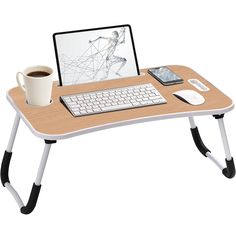 a computer desk with a laptop on it and a cup of coffee next to it