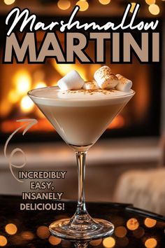 a martini with marshmallows in it sitting on a table