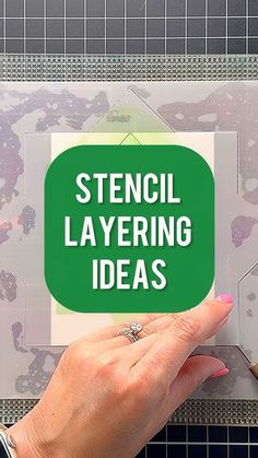 a person holding up a sticker that says stencil layering ideas on it