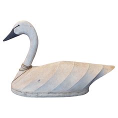 a white swan statue sitting in front of a white background