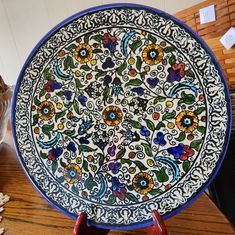 a decorative plate is sitting on a table