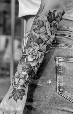 a woman's arm with flowers on it