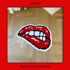 the rug is shaped like a mouth with red lipstick on it and has white teeth