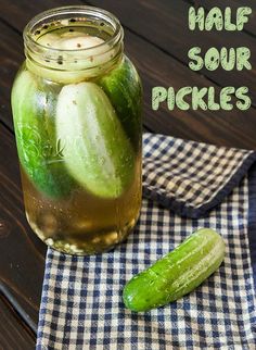 a jar filled with pickles sitting on top of a table