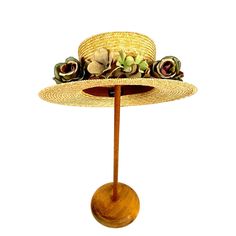 Step back in time with our Victorian Boater Straw Hat, a stunning vintage straw boater with a boho twist.  Made for the modern woman who loves a touch of nostalgia, this sun hat features delicate fabric flowers for a feminine touch. The wide brim provides ample shade for those sunny days, while the lightweight straw material keeps you cool and comfortable. Perfect for picnics, garden parties, or simply adding a chic touch to your everyday attire.  Embrace your inner bohemian spirit with this cha Vintage Brown Straw Hat For Summer, Bohemian Short Brim Panama Hat For Garden Party, Vintage Brown Straw Hat, Bohemian Flat Brim Panama Hat For Garden Party, Vintage Adjustable Hat Bands For Vacation, Vintage Brown Hat Bands For Summer, Adjustable Vintage Panama Hat, Vintage Straw Hat For Beach, Bohemian Boater Hat For Garden Party With Curved Brim