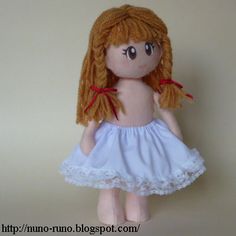 a doll with red hair wearing a blue dress