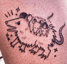 a rat and mouse tattoo on the left side of the right leg, with stars around it