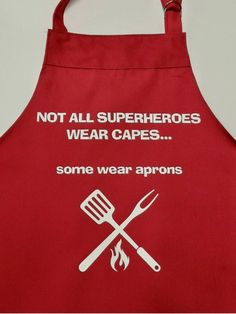 a red apron that says not all superheros wear capes some wear aprons