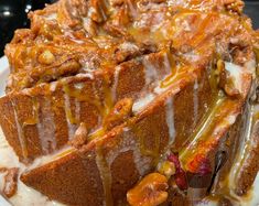 a close up of a cake on a plate with icing drizzled