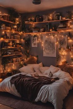 an unmade bed with lots of lights on the wall above it and bookshelves