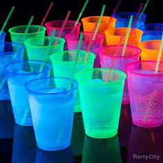 many different colored cups with straws in them