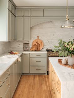 a kitchen with wooden floors and gray cabinets