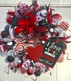 a valentine's day mesh wreath with i love you to the moon and back