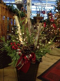 a planter filled with christmas trees and lights