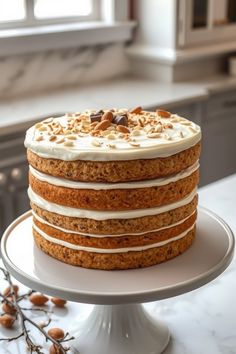 a cake with white frosting and nuts on top