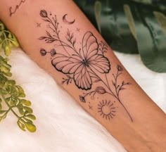 a woman's foot with a flower tattoo on the left side of her leg