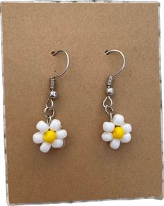 Dainty Flower Earrings With Ear Wire For Summer, Cute Flower Shaped Earrings With Ear Wire, Cute Adjustable Flower Charm Earrings, White Daisy Flower Earrings For Spring, Summer White Nickel-free Flower Earrings, White Nickel-free Flower Earrings For Summer, Cute White Flower Earrings For Summer, Dainty Daisy-shaped Earrings With Flower Charm, White Daisy-shaped Hypoallergenic Flower Earrings