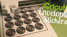 a close up of a machine with some stickers on it and the words cricut envelope stickers