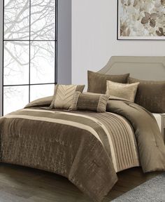 a bed with brown and tan comforters in a room