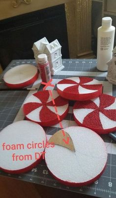 several circles are cut out and placed on a cutting board with scissors, glue, and other crafting supplies