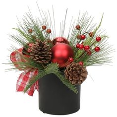 a christmas centerpiece with pine cones, berries and baubles in a black container