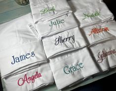 six personalized pillow cases sitting on top of a table