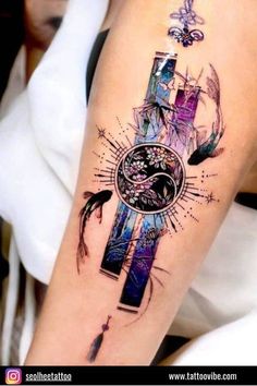 a cross tattoo on the arm with an image of a bird flying over it and stars