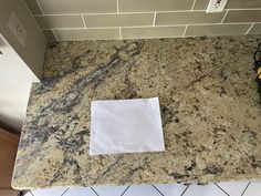 a kitchen counter with a piece of paper on it