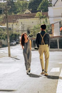 a man and woman walking down the street