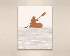 a person in a boat on the water with a paddle and an orange silhouette over it