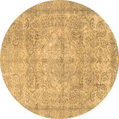 a round rug with an intricate design on the top and bottom, in gold tones