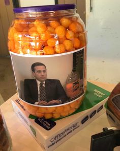 a jar filled with oranges sitting on top of a table