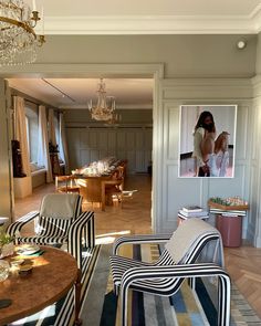 a living room filled with furniture and a chandelier