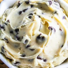 a white bowl filled with ice cream next to crackers