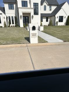 a large white house sitting on the side of a road