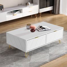 a white coffee table with two drawers on each side and an open magazine in front of it