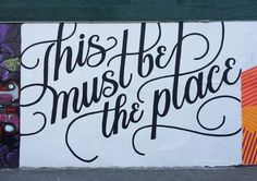 a mural on the side of a building that says, this must be the place