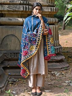 This turquoise shawl/dupatta is crafted in organic khadi cotton fabric. It is Heavily aari Embroidered with different kashmiri motif. It is fenced with wine dyed cotton tassel lace. For winters it is perfect as a fancy shawl and for festive it is perfect to carry on your fancy outifit. Color: Blue Fabric: 100% cotton base khadi Fabric Work Details: Embroidered, embellished with fancy laces and fringes Meausrements: Length - 200 CM Width - 75 CM Note: The product will be delivered within 10-15 da Khadi Fabric, Fancy Shawl, Tassel Lace, Floral Chiffon Dress, Embroidered Dupatta, Ethnic Dress, Floral Chiffon, Online Fashion Stores, Festival Wear