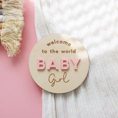 a wooden sign that says welcome to the world baby girl