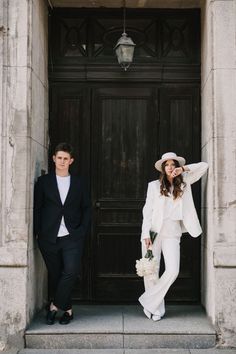 a man and woman standing in front of a door