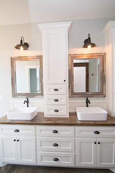 a bathroom with double sinks and two mirrors on the wall next to eachother